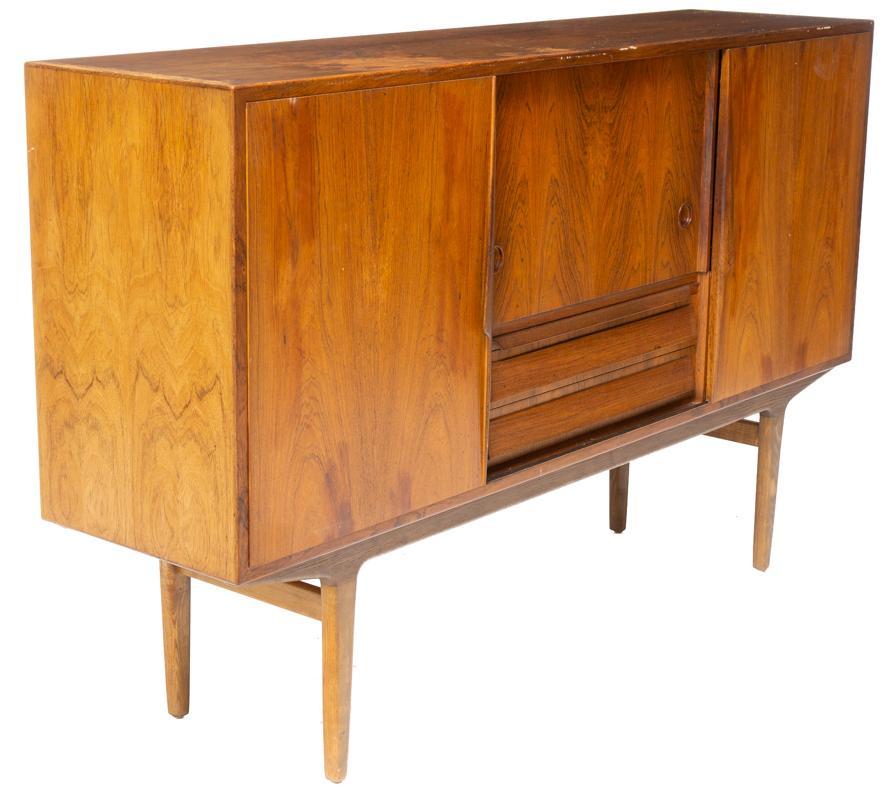 Danish Mid-Century Sideboard: Danish Mid-Century sideboard, 3-sliding doors open to shelved and mirrored interior, pin legs, 2-drawers 43.5" tall x 70.5" wide x 17.5" deep Condition: Water damage to top, crack in mirror State-wide
