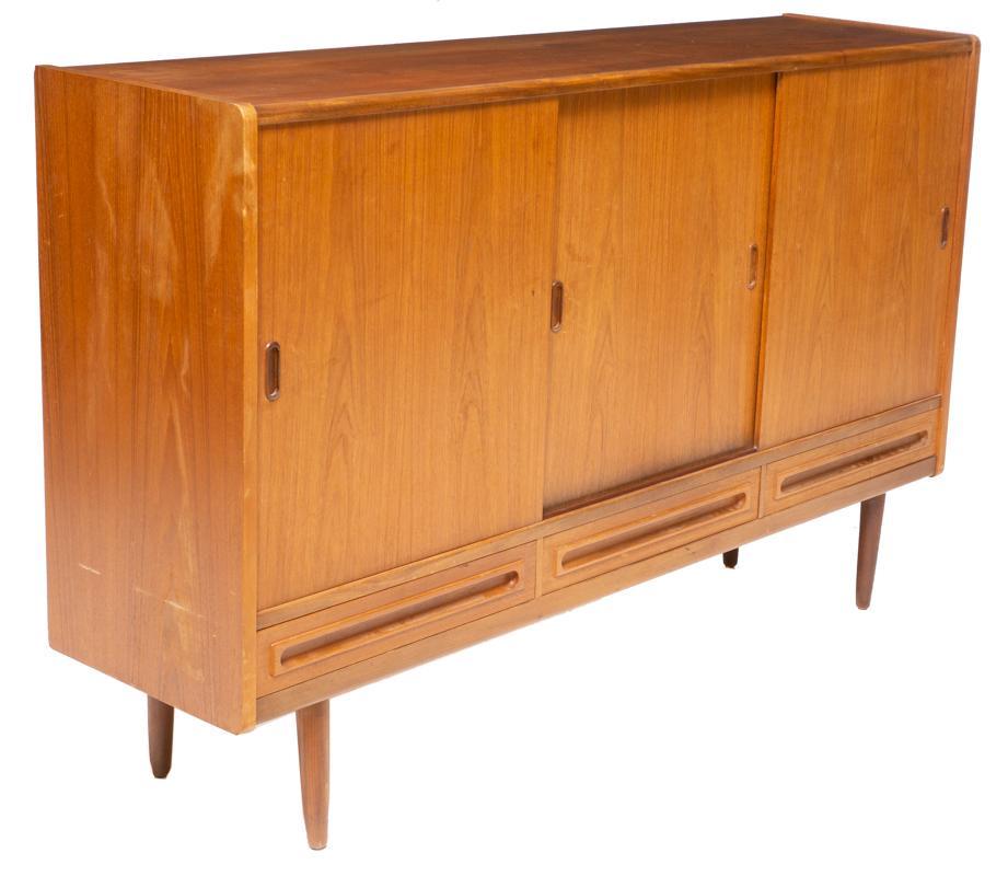 Danish Mid-Century Sideboard: Danish Mid-Century sideboard, 3-sliding doors open to fitted interior, 3-drawers, pin legs 42" tall x 67" wide x 17" deep Condition: Water damage on left side and interior State-wide delivery is avail