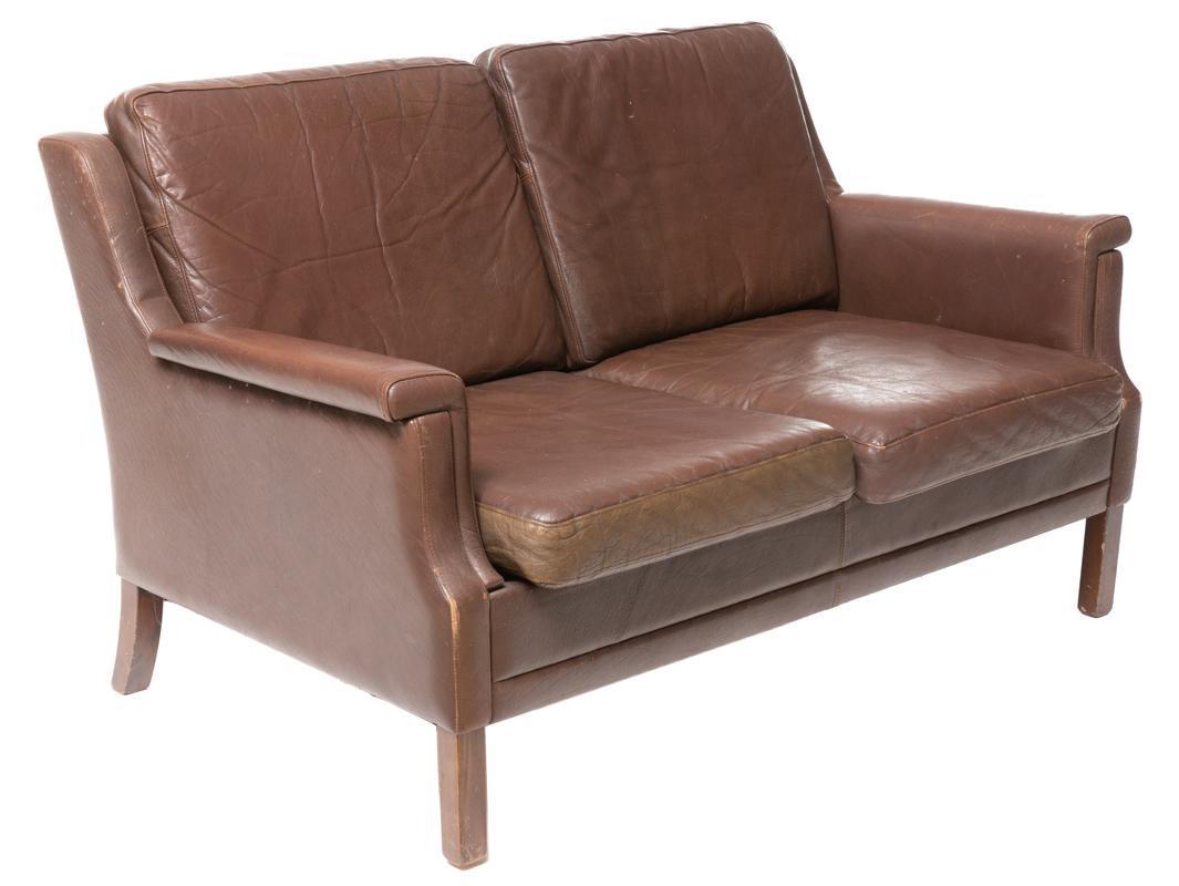 Danish Mid-Century Leather Sofa: Danish Mid-Century leather sofa, 2-seat, wooden legs 30.5" tall x 52.5" wide x 33.5" deep State-wide delivery is available for this item. Please email shipping@vogtauction.com or call 210-822-6155 for