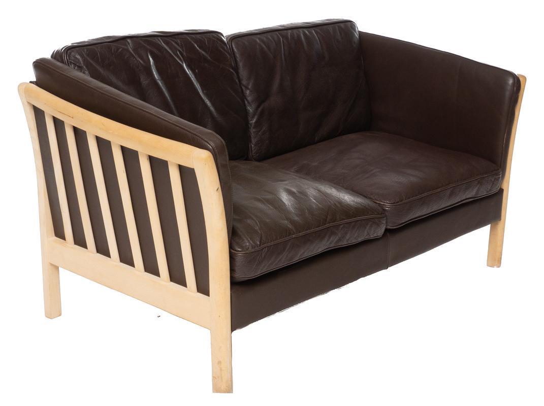 Danish Mid-Century Leather Sofa: Danish Mid-Century leather sofa, wooden sides and legs, 2-seat 31.5" tall x 55.5" wide x 30" deep State-wide delivery is available for this item. Please email shipping@vogtauction.com or call 210-822-