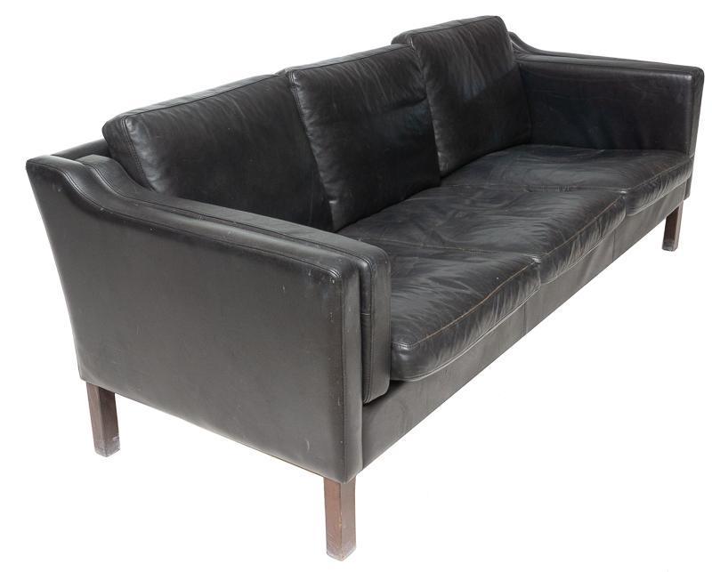 Danish Mid-Century Leather Sofa: Danish Mid-Century leather sofa, wooden legs, 3-seat 29" tall x 75" wide x 31" deep State-wide delivery is available for this item. Please email shipping@vogtauction.com or call 210-822-6155 for a quo