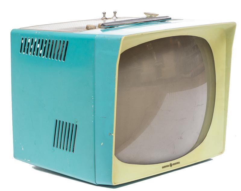Vintage General Electric Television: Provenance: A New Braunfels, TX Estate Vintage General Electric television, teal and lime green, with handle, includes original knobs 14"h x 16"w x 15"d