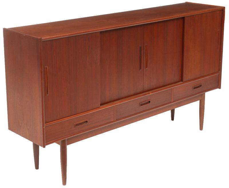Danish Mid-Century Sideboard: Mid-Century sideboard, 4-sliding doors open to shelved and mirrored interior, 5-drawers, pin legs 44"h x 77"w x 17.5"d State-wide delivery is available for this item. Please email shipping@vogtauction
