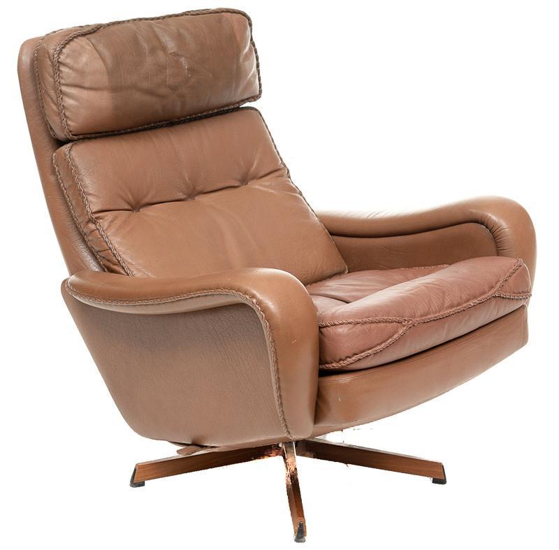 Mid-Century Danish Leather Arm Chair: Mid-Century Danish leather arm chair, formica swivel base, stitched leather accents, reclines, marked Made in Denmark on base 37"h x 30"w x 35"d State-wide delivery is available for this item. Please 