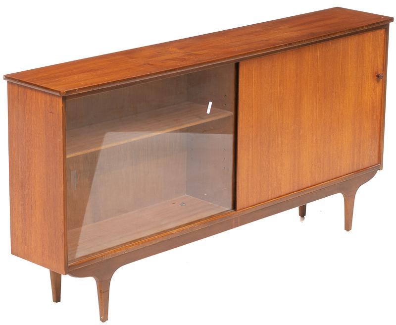 Mid-Century Teak Glazed Sideboard: Mid-Century teak glazed sideboard, single-glass sliding door and single-wooden sliding door open to shelved interior, pin legs 30.5"h x 61.5"w x 11"d State-wide delivery is available for this item. Pl
