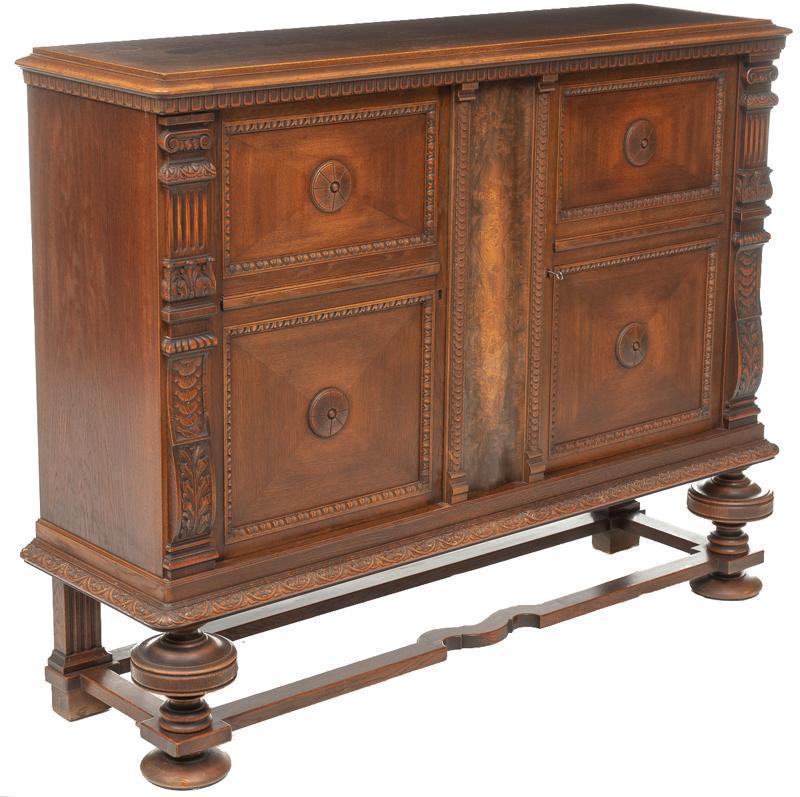 Jacobean-Style Carved Sideboard: Jacobean-style carved sideboard, 2-doors open to shelved interior, turned and stretchered legs 52"h x 67"w x 19.5"d State-wide delivery is available for this item. Please email shipping@vogtauction.co