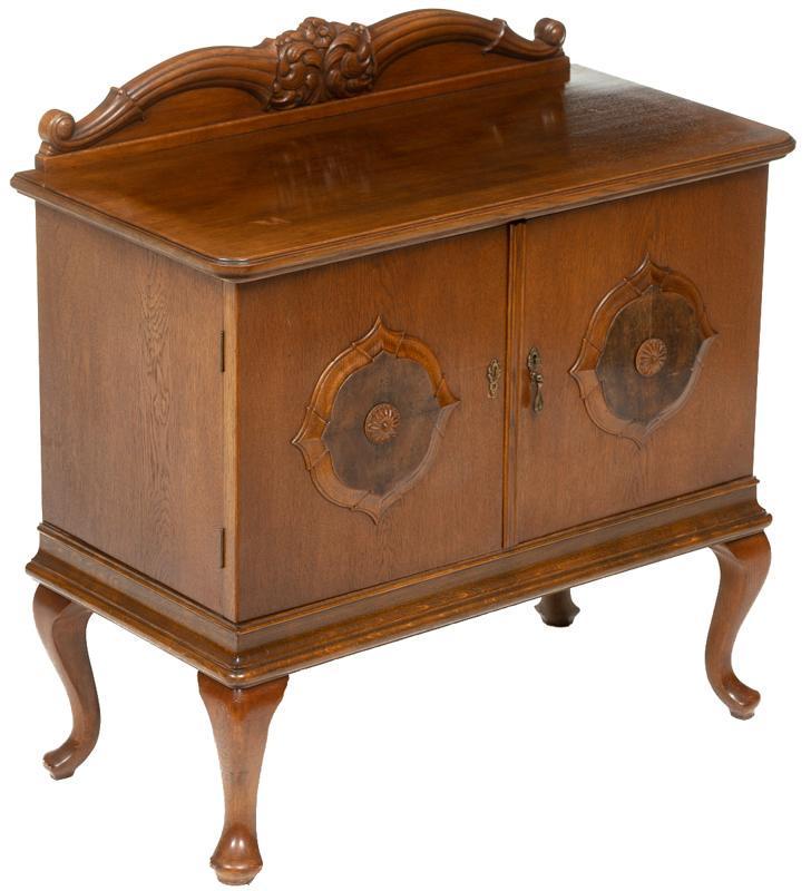 Biedermeier Cabinet: Biedermeier cabinet, carved mantle, inlay, metal hardware, 2-doors open to shelved interior, cabriole legs 38"h x 37.5"w x 18.5"d Condition: Missing pull on left door State-wide delivery is available 