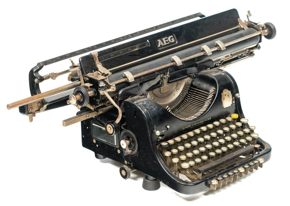 Vintage AEG Typewriter: Vintage AEG frontstriking typewriter, with carriage return and keys 10"h x 29"w x 16"d In-house shipping and delivery is available on this item. Please email shipping@vogtauction.com or call 210-822-6