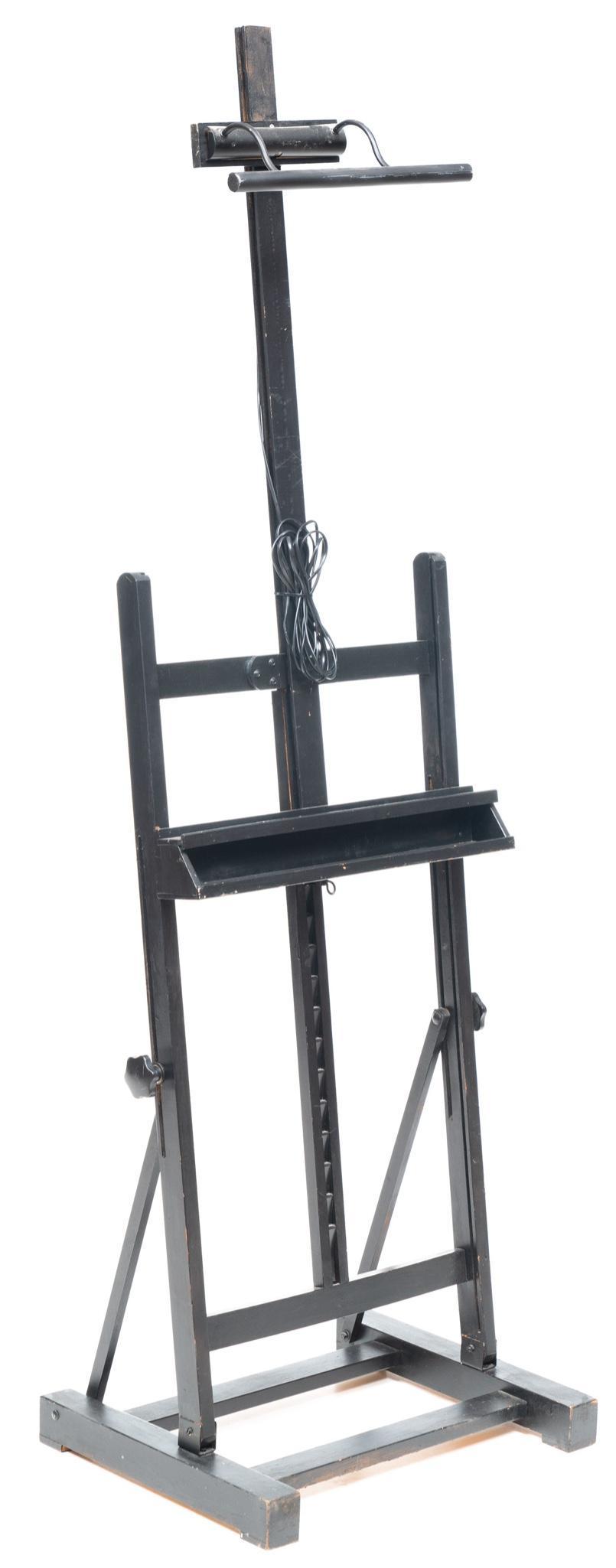 Vintage Art Easel: Vintage black painted wooden art easel with overhead display lamp 86"h x 27"w Condition: Wired European State wide delivery is available for this item. Please email shipping@vogtauction.com or call 21