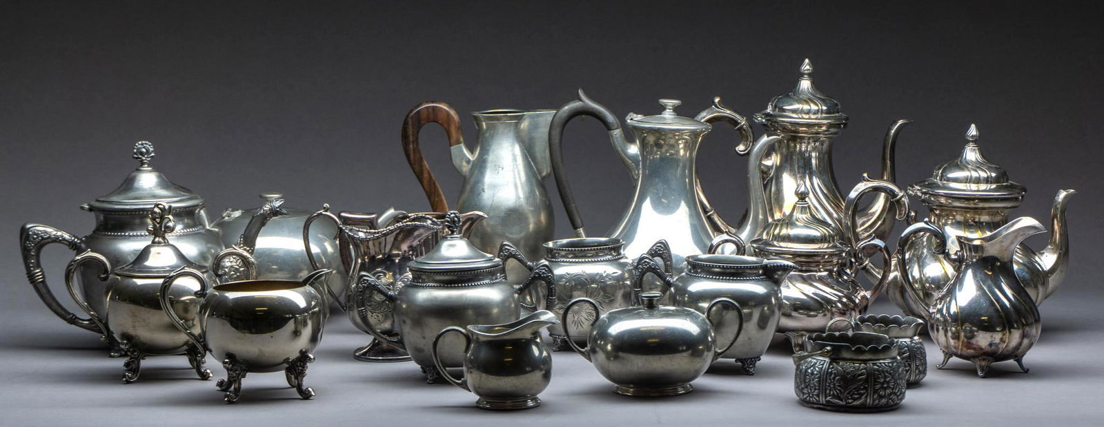 Lot of 19 Vintage Silverplate and Pewter Servingware: Lot of ninteen pieces of vintage silveplate and pewter servingware, includes tea pots, coffee pots, sugar dishes, creamers, etc 10"h x 9"d/ largest Provenance: The Estate of Mary Ann Delmer, long-time
