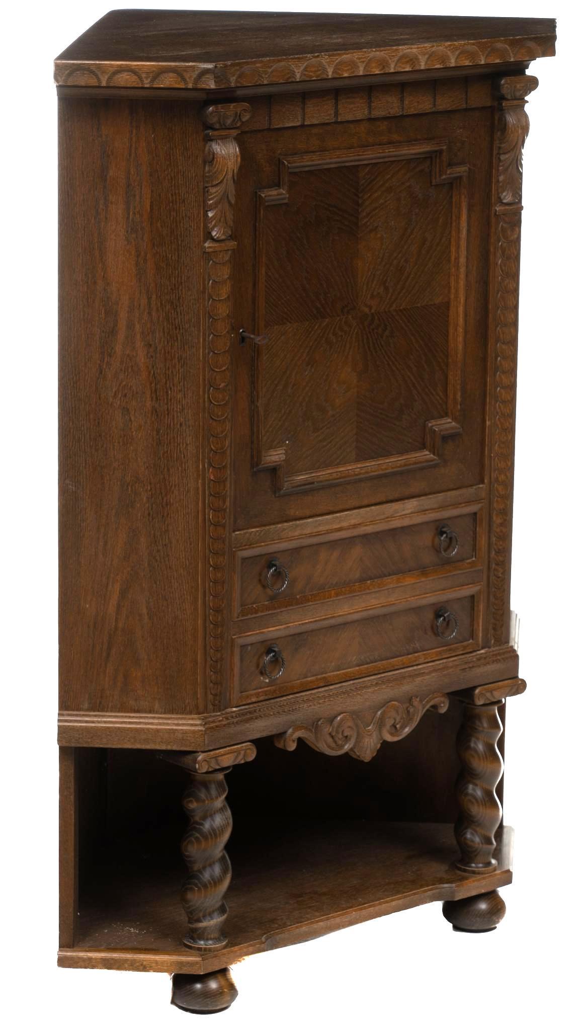 Corner Cabinet: Corner cabinet, single door opens to shelved interior over two drawers, rising on barley twist legs with carved accents with pad feet 51.5"h x 36"w x 23"d State wide delivery is available for this ite