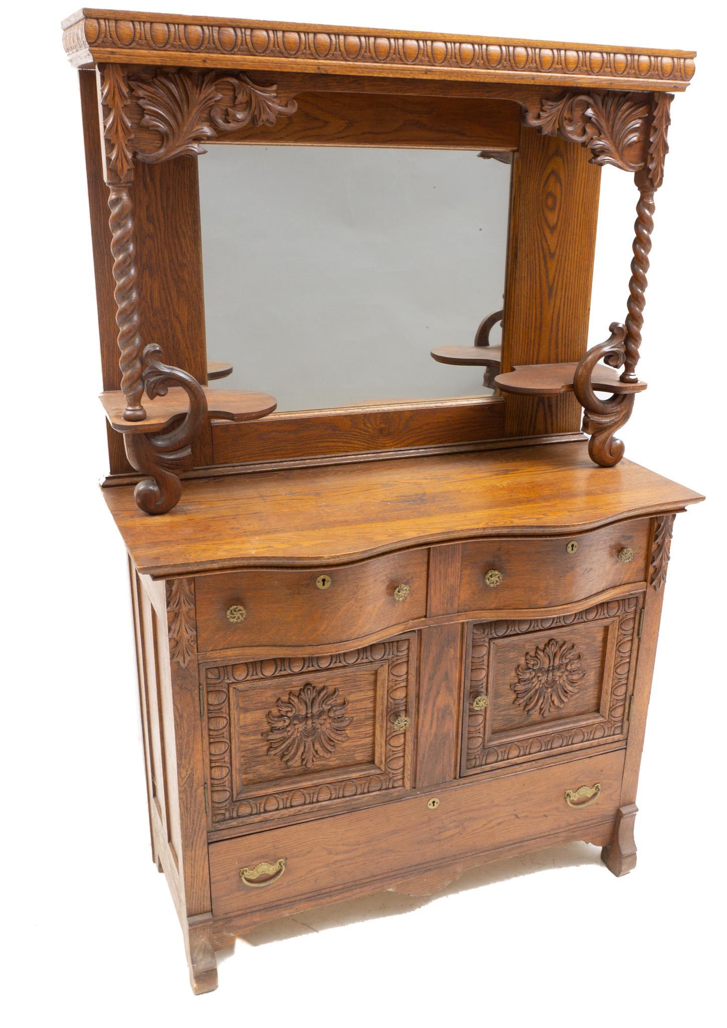 American Mirrored Buffet: American buffet, twist and carved braces hold mirrored back, two drawers over two doors, above single drawer, rising on block legs 72 x 46 x 19.5" We happily provide seamless shipping services on ever
