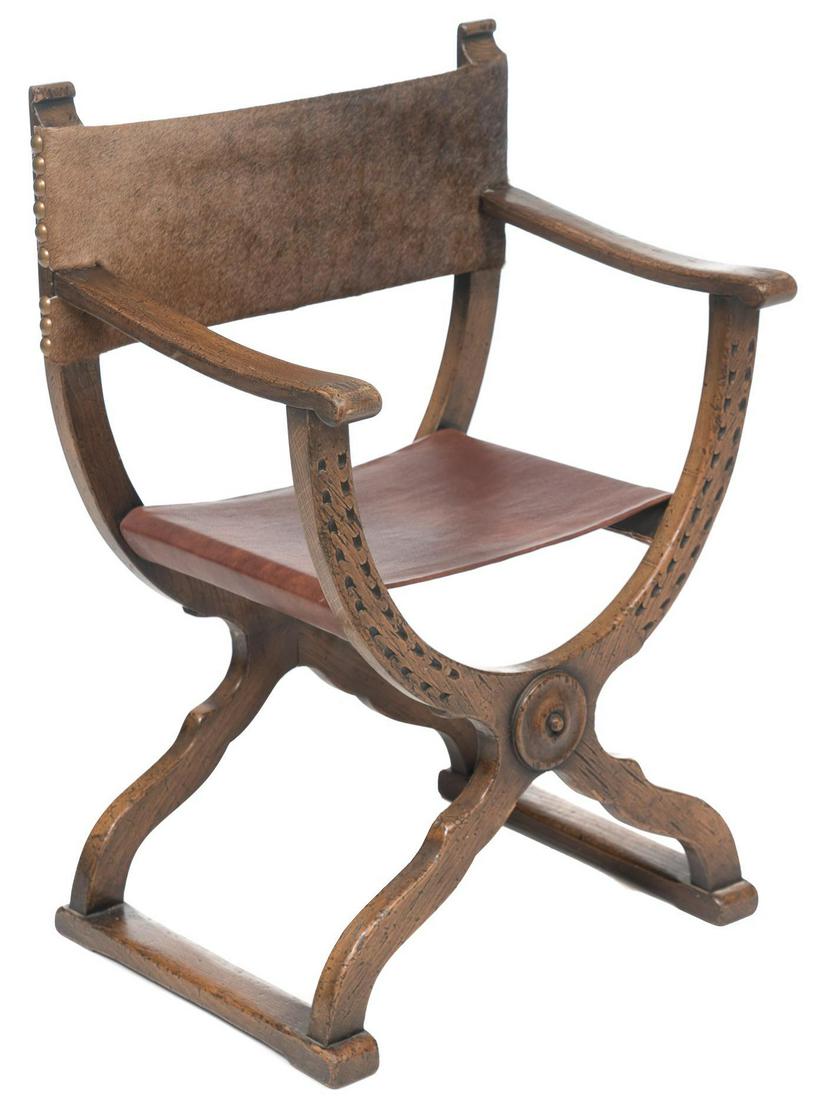 Carved Italian Savonarola Chair: Carved Italian savonarola chair, carved mantle with nail head trim, hide and leather seat and back 35 x 24 x 15" Provenance: A Spring Branch, TX Estate We happily provide seamless shipping services on
