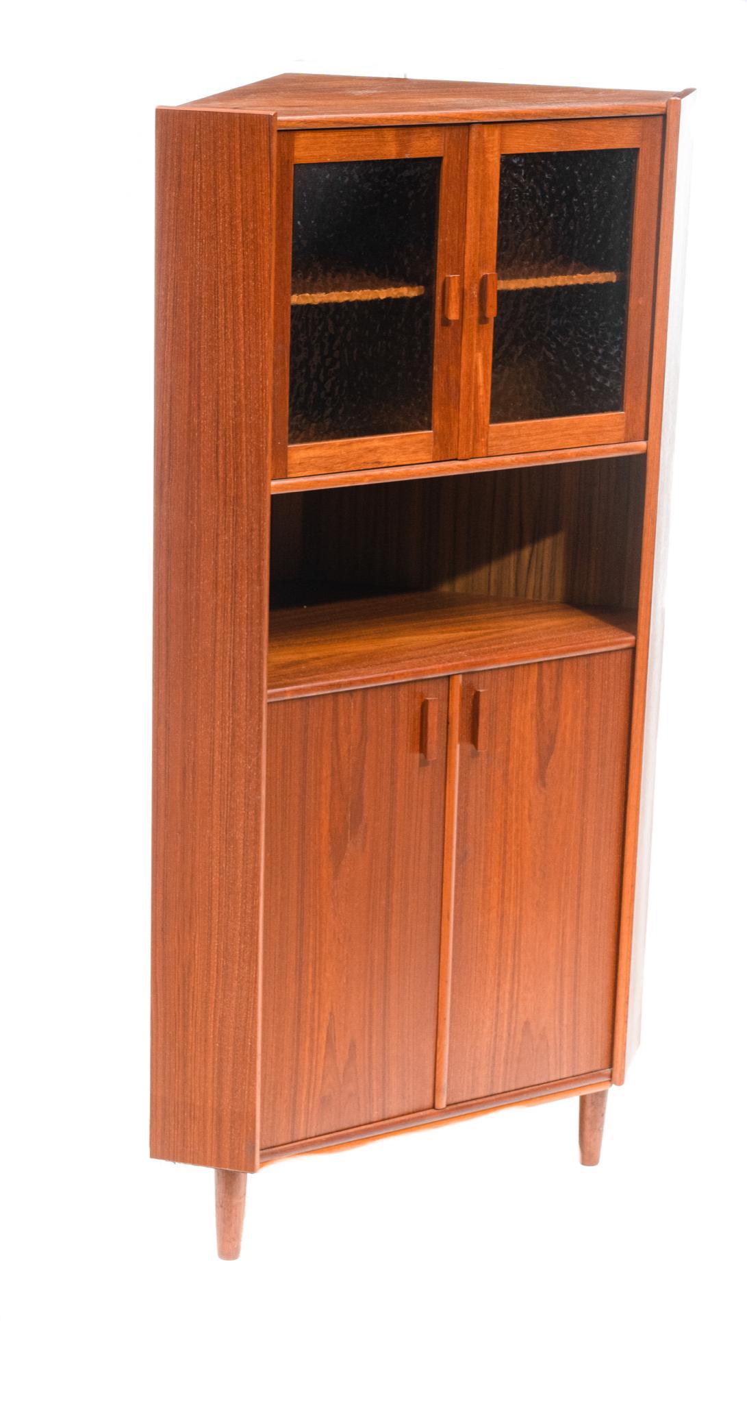 Danish Mid-Century Frosted Glass Corner Cabinet: Danish Mid-Century corner cabinet, two frosted glass doors open to shelved interior, open shelf above two doors, rising on pin legs 64.5"h x 34"w x 24"d We happily provide seamless shipping services o