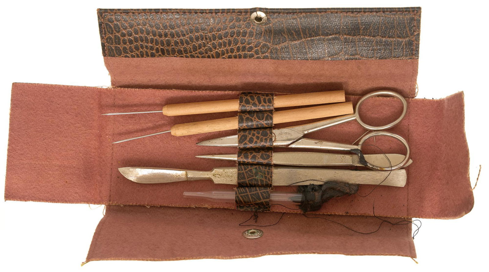 Pocket Size Field Surgical Kit: Pocket Size Field Surgical Kit for minor combat surgery Includes: scissors, tweezers, vial, scalpel, 2 needle probes, & a threading needle for stitching Condition: spilled tar substance on case an