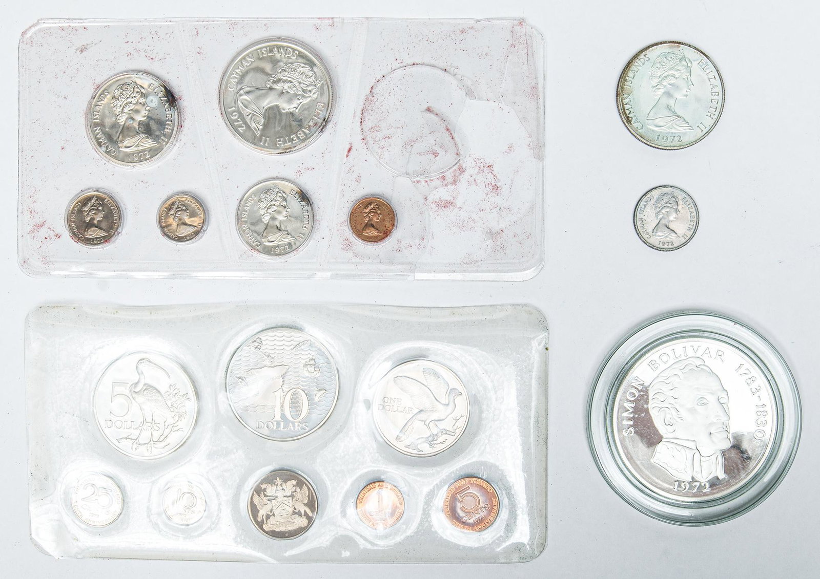 3 1972 Proof Sets from Cayman Islands, Panama, &: Includes: 8.7oz. Total -1972 Cayman Islands Proof 8-coin set in case(Minted at Royal Canadian Mint) w/ case sleeve; 2 coins are not in sealed plastic; interior of case has moisture damage -1972 Trinid