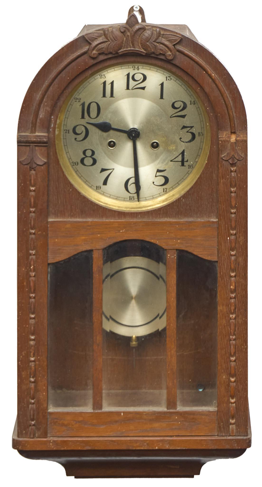 Art Deco Regulator Clock: Vintage wall hanging regulator clock, having Art Deco wooden encasement with metal face, carved accents, to include pendulum 26"h x 12"w x 6"d We happily provide seamless shipping services on everyt