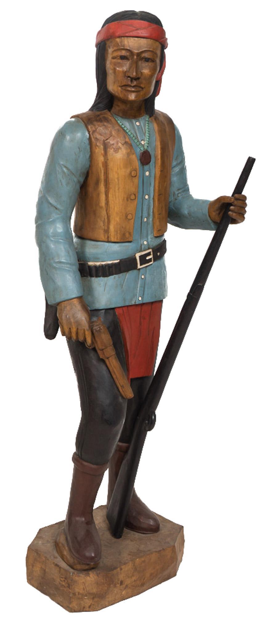 Arrtib. to Apache Nation, Wooden Native American Hunter: Unknown artist, carved wooden Native American hunter with removable prop revolver and rifle gun, arrtib. to Apache Nation, freestanding 68"h x 17"w x 18.5"d Provenance: A Spring Branch, Texas collecti