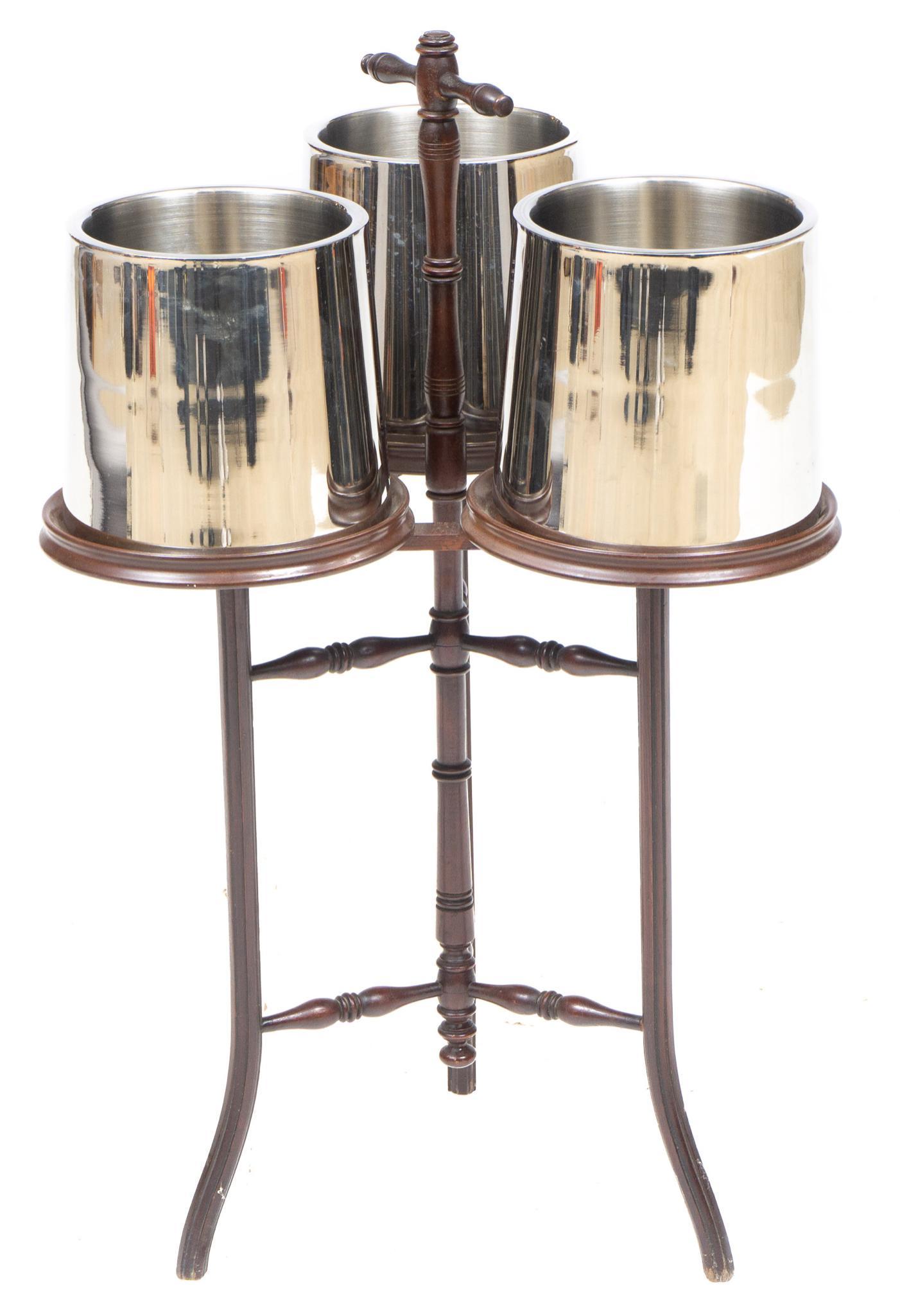 Art Deco Drink Carrier: Art Deco drink carrier, having three metal wine coolers on wooden frame, with handle and tripod base 31"h x 18"d Provenance: The collection of philanthropist Francie Whittenberg, San Antonio, Texas We