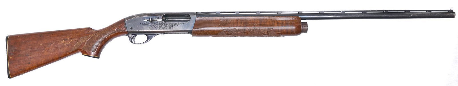Remington 1100 20-Gauge Semi-Auto Shotgun: Serial: 387829X Manufacturer: Remington Model: 1100 Caliber: 20 Ga. Barrel length: 27.75" (modified choke) Condition: Fair; fair amount of wear & handling marks in wood stock; barrel & receiver have a