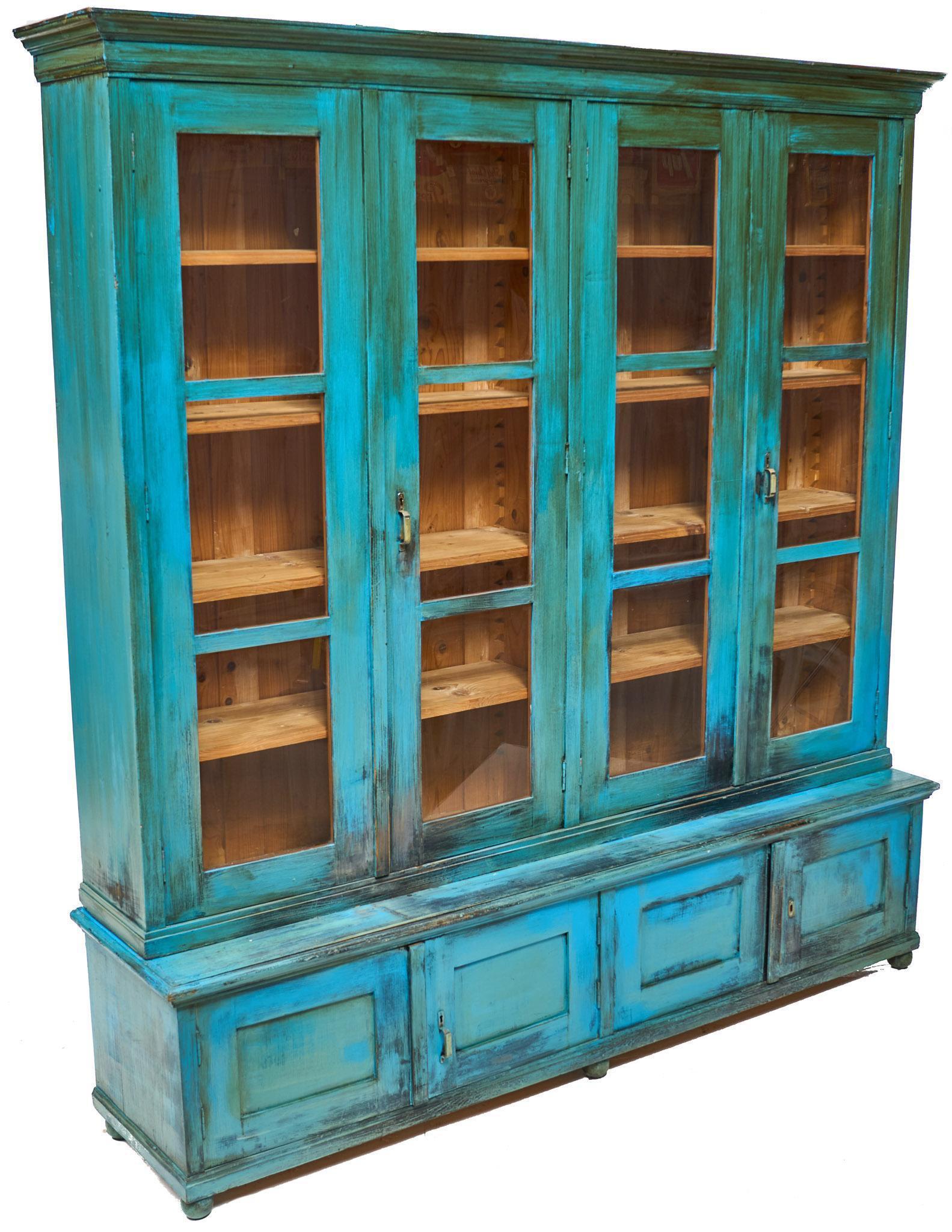 Rustic General Store Shop Display Case: Rustic general store shop display case, blue paint remnants, four glazed doors open to shelved interior, above four doors, metal hardware 87"h x 80.5"w x 18"d We happily provide seamless shipping serv
