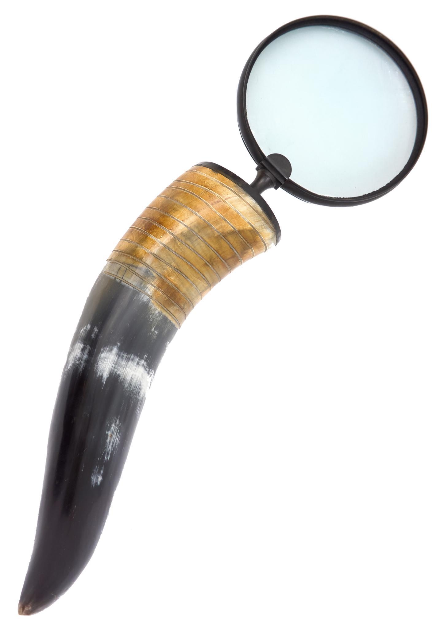 Horn-Handled Magnifier: Magnifying glass with metal rim, bearing multicolored horn handle 18"h x 6" x 4"d Provenance: A San Antonio, Texas collection We happily provide seamless shipping services on everything we sell. Pleas