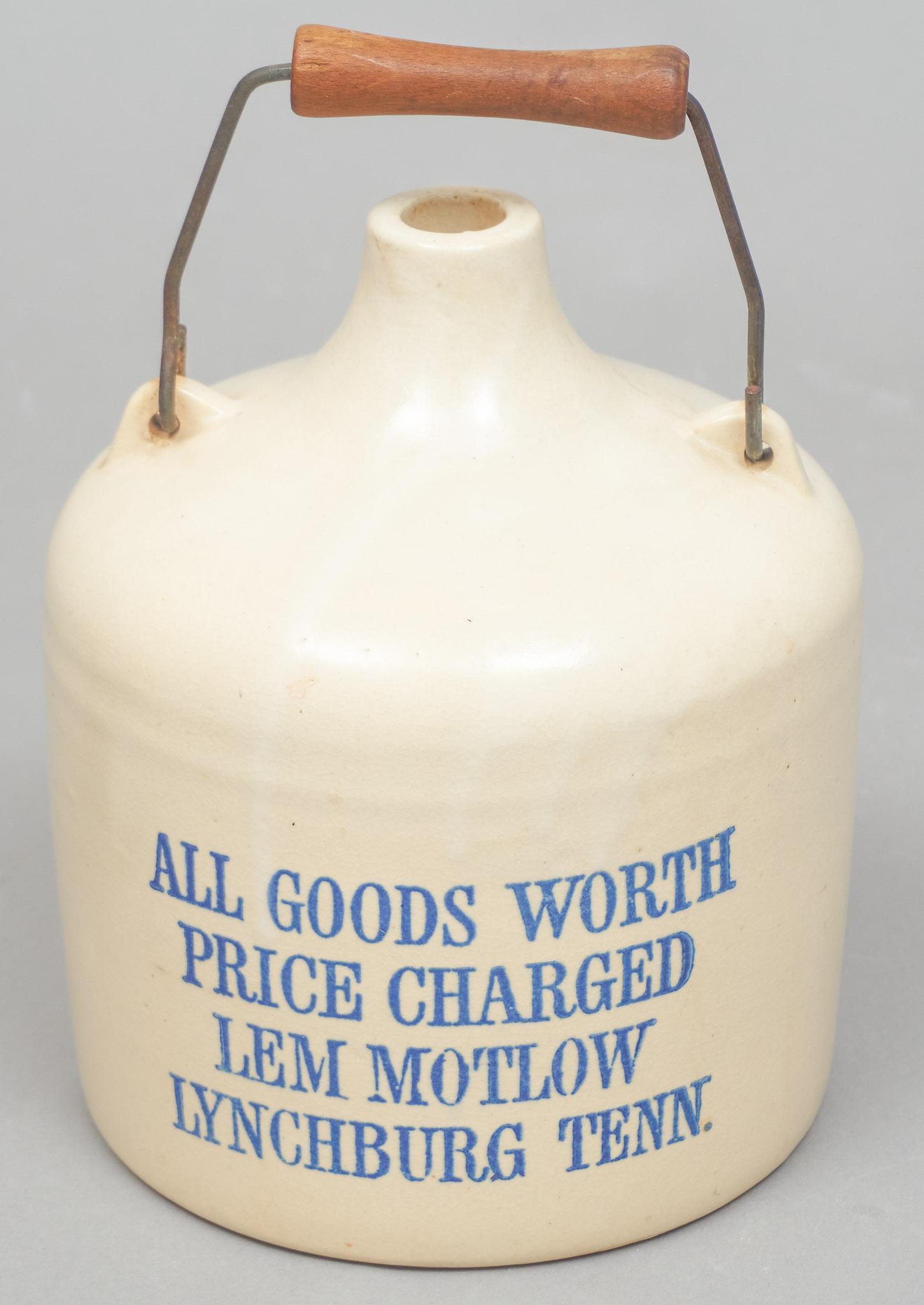Lem Motlow (1869-1947) Lynchburg, TN Whiskey Jug: Lem Motlow glazed pottery whiskey jug, Lynchburg, TN, with metal handle 11"h x 7.5"d Provenance: The Hendrix Collection (Seguin, TX) Lem Motlow (1869-1947) was said to have had a head for numbers, and