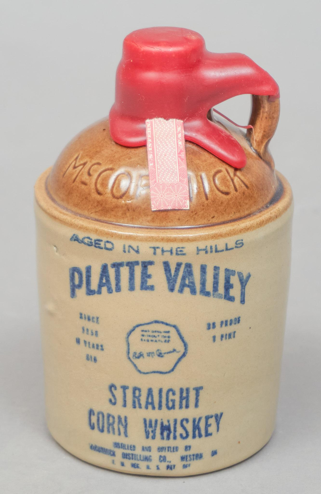 McCormick Platte Valley Straight Corn Whiskey Jug: McCormick Straight Corn Whiskey Platte Valley Weston, Missouri miniature crock jug, still wax sealed with contents inside 6"h x 3.5"d We happily provide seamless shipping services on everything we sel