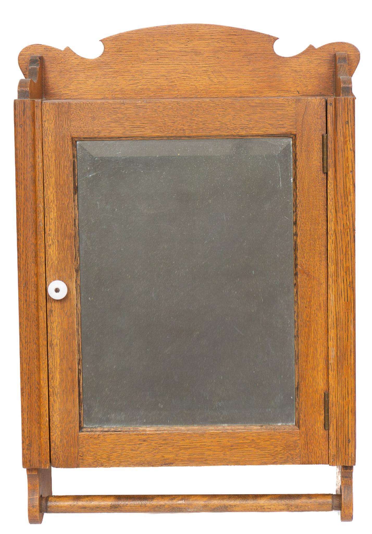 Mirrored Medicine Cabinet: Wall hanging medicine cabinet, single mirrored door opens to shelved interior, above towel rail 31"h x 18"w x 7"d Provenance: An Olmos Park, Texas collection We happily provide seamless shipping servi