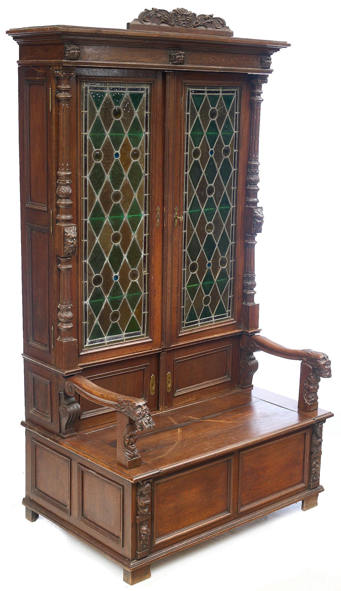 French Renaissance Style Stained Glass Bishops Seat: Exceptional French Renaissance style bishops seat, featuring two colorful stained glass doors, with flanking portraits, two smaller wooden doors over seat with carved arms, hinged seat opens to storag