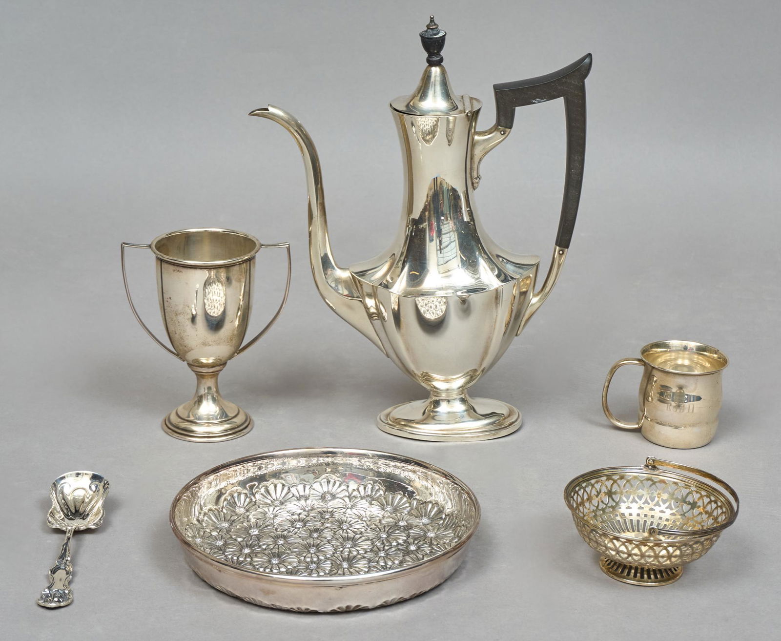 Collection Vintage Sterling Silver Hollowware: Sterling silver tableware including Italian repousse daisy dish, Gorham Plymouth coffee pot, and small loving cup, Wallace lion spoon, baby cup, and perforated candy dish Coffee pot height: 10 3/4