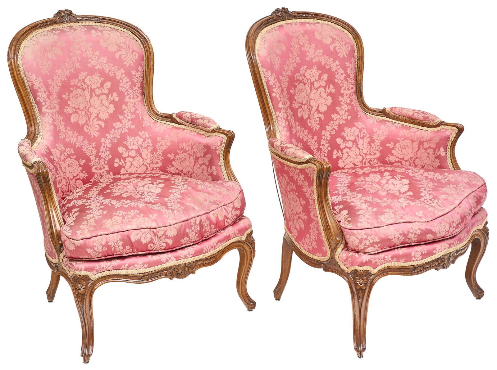 Pair of Louis XV Style Armchairs: Pair of upholstered Louis XV style armchairs upholstered in pink damask, reeded apron with floral motif, rising on cabriole legs 38"h x 26"w x 22"d/ each We happily provide seamless shipping services 