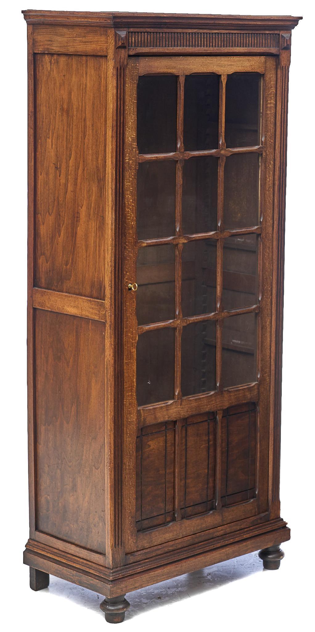 Louis XIII Style Bonnetiere: Louis XIII style bonnetiere having glazed front with wooden astragals, cornice top, and bun feet 63"h x 27.5"w x 14.5"d We happily provide seamless shipping services on everything we sell.