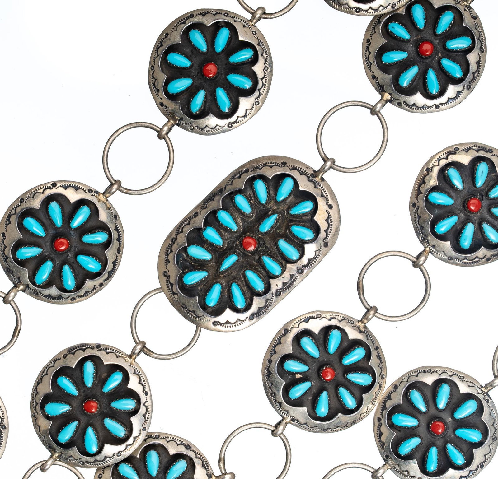 Turquoise Coral Sterling Concho Belt: Floral sterling silver conchos of turquoise and coral. Belt length 38", concho width 1 3/8", total weight 130.8 grams. Provenance: The Estate of Joan & Herbert Hahn (San Antonio, Texas) We happily pro