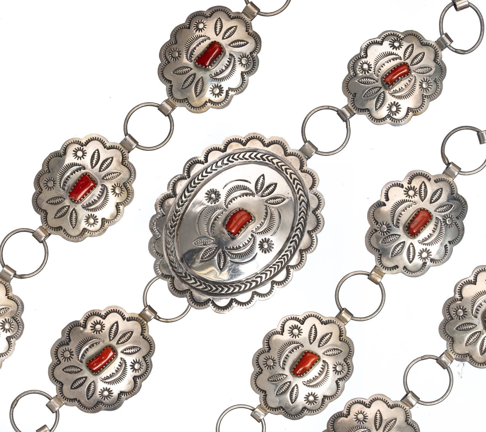 Native American Coral Sterling Silver Concho Belt: Signed by Navajo artisan Ida Payton, stamp work conchos with branch coral, Belt length 44 1/2", concho width 1 1/4", total weight 173.4 grams. Provenance: The Estate of Joan & Herbert Hahn (San Antoni