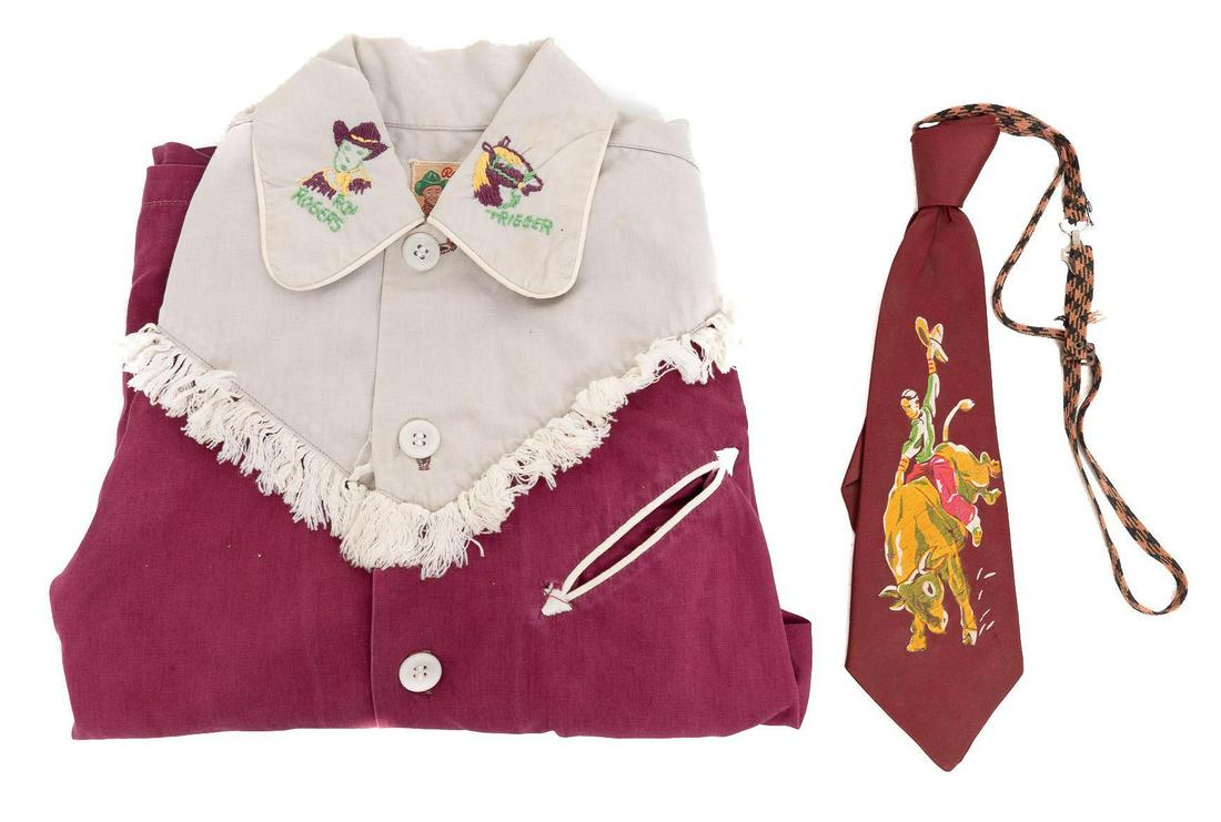 Period Roy Rogers Children's Shirt and Matching Trigger Tie: Roy Rogers children's shirt, featuring embroidered collar and front pocket, to include matching Trigger tie 21"h x 44"w Provenance: An Alamo Heights, Texas collection We happily provide seamless shipp