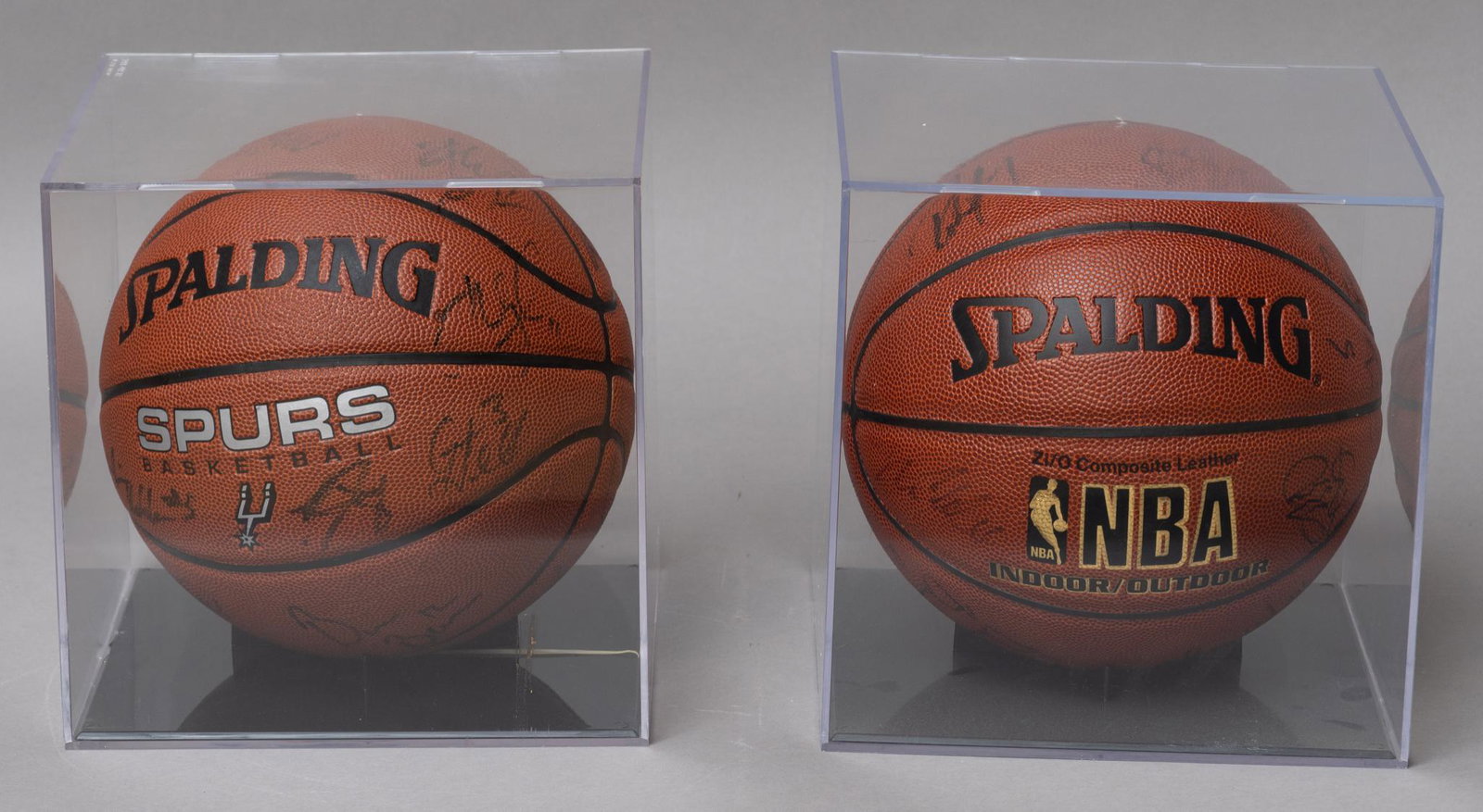 Pair of Signed San Antonio Spurs Basketballs: Pair of signed San Antonio Spurs basketballs, inside glass cases 10"h x 10"w x 10"d/ largest Provenance: A San Antonio, Texas collection We happily provide seamless shipping services on everything we 