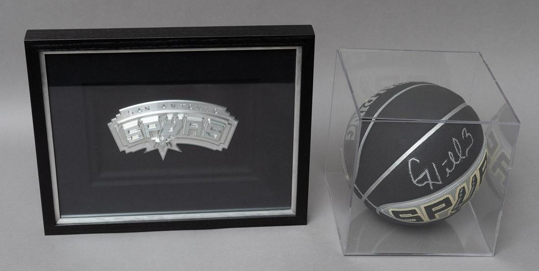 Pair of San Antonio Spurs Memorabilia: Pair of San Antonio Spurs memorabilia, to include framed Spurs logo, and signed black and silver Spurs basketball 10"h x 10"w x 10"d Provenance: A San Antonio, Texas collection We happily provide seam
