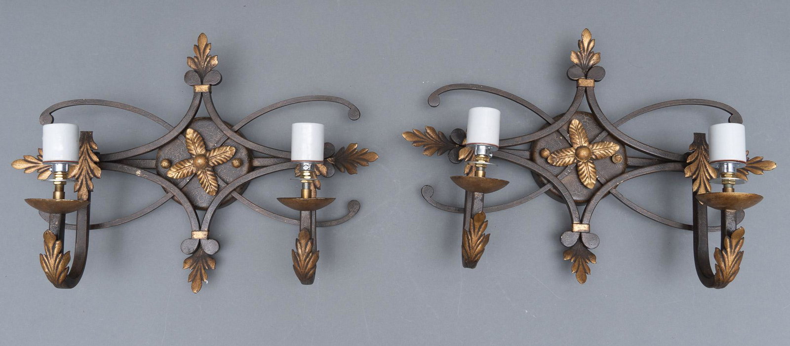 Pair of Formica Shade Wall Sconces: Pair of matching wall scones, having a scroll and leaf motif with bronze colored accents, featuring formica shades 13"h x 18"w x 7"d Provenance: A Terrell Hills, Texas collection We happily provide se