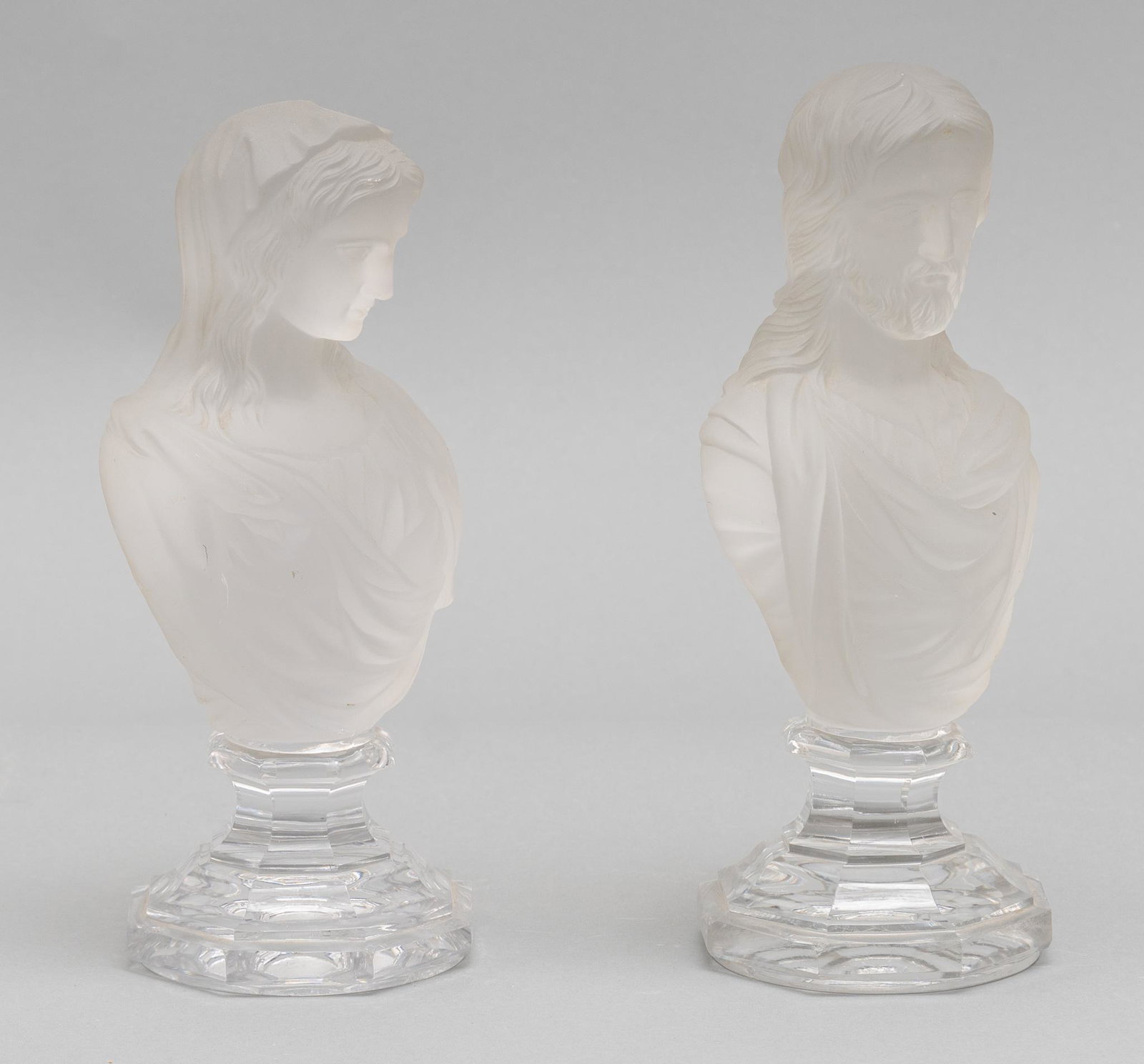 Pair of Baccarat Busts, Jesus and Madonna: Pair of Baccarat molded glass busts, depicting Jesus Christ and Madonna, free-standing, both signed "Baccarat / Depose" 11"h x 6"w x 4"d We happily provide seamless shipping services on everything we 