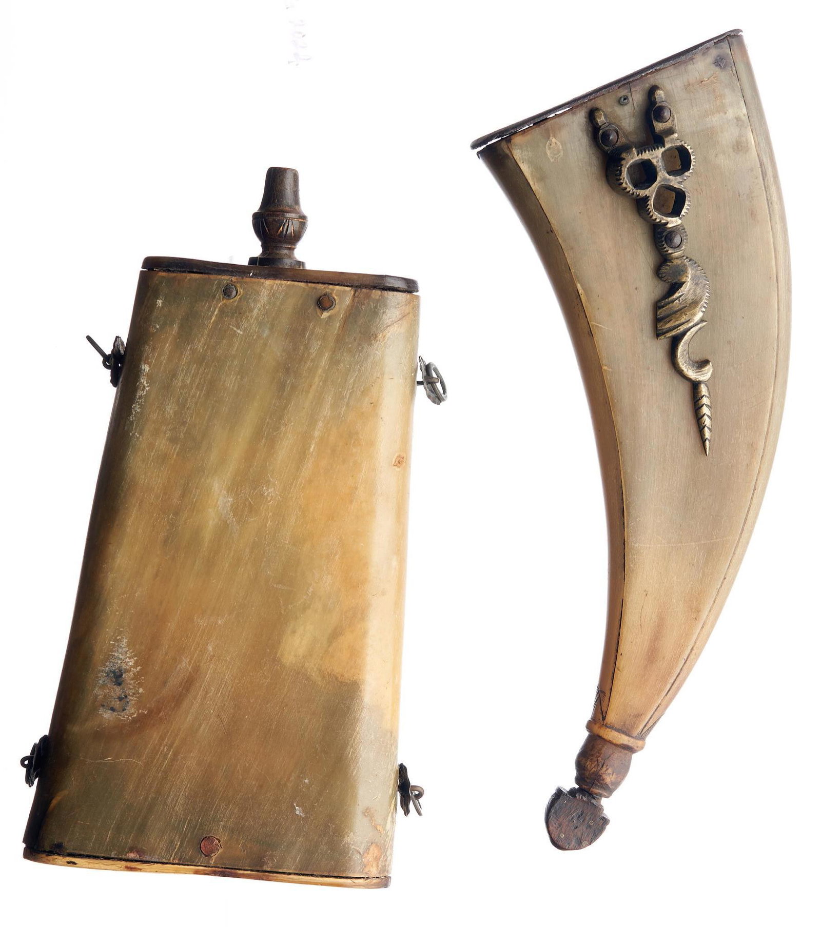 Pair of 17th C. Powder Horn Flasks: Includes: -(1)flattened curved horn flask w/ brass spanneron one side; light carving along sides; iron base plate -(2)flattened squared horn flask w/ brass suspension loops; light carving on plug; hor