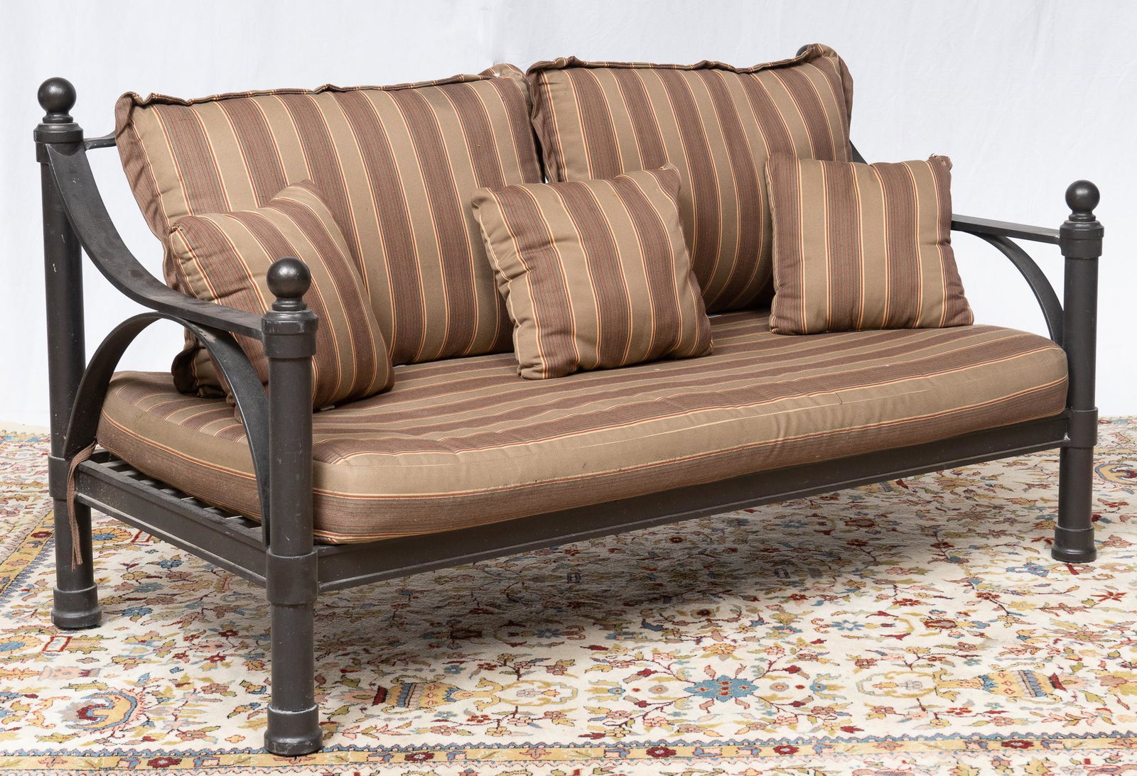 Outdoor Couch: Outdoor couch with metal frame, striped cushions, featuring geometric back, 53"h x 72"w x 34"d Provenance: A San Antonio, Texas collection Note: matching chairs and coffee table to be sold