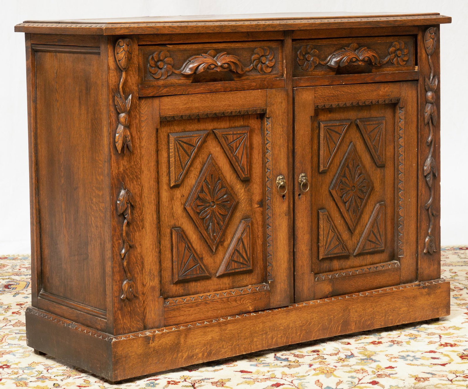 Renaissance Style Credenza: Renaissance style credenza, featuring carved flower motif, having beveled top, above diamond doors, leading to interior shelf 36"h x 47"w x 19"d Provenance: A San Antonio, Texas collection