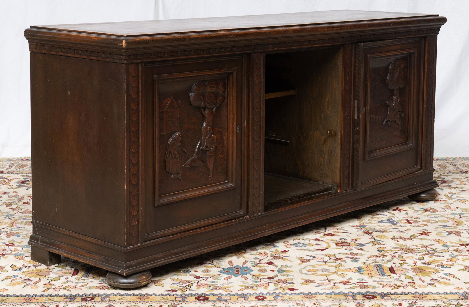 Hand-Carved Wooden Sideboard: Hand-carved wooden sideboard, having beveled top, depicting carved feudal scene, with cabinets leading to shelves 33"h x 73"w x 21"h Provenance: A San Antonio, Texas collection Note: missi