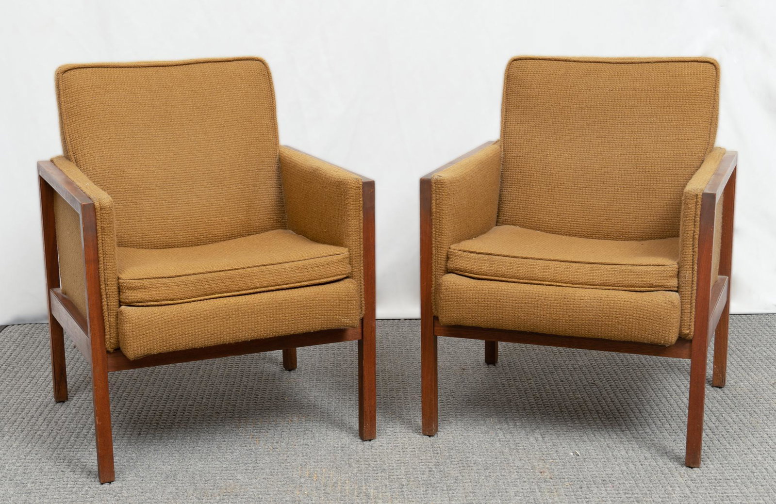 Pair of Mid-Century Style Straightbacked Armchairs: Pair of matching mid-century straightbacked armchairs, having wooden frame and tan upholstery, supported on block legs 33"h x 25"w x 26"d Provenance: A San Antonio, Texas collection We hap