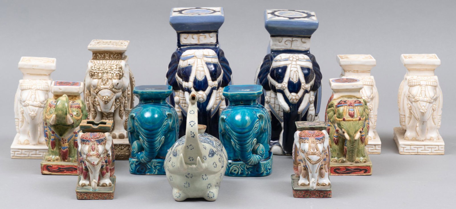 Collection of (13) Ceramic Elephant Garden Stool Bookends: Collection of thirteen ceramic elephants, to include book ends, pair of marked vintage When Hing ashtrays, and a candleholder 11"h x 5"w x 5"d Provenance: A Waco, Texas collection We happi