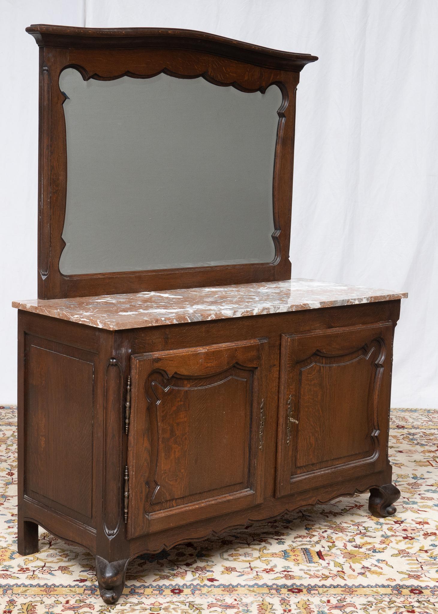 Marble-Top Vanity: Marble top vanity, featuring mirror in hand-carved frame, with cabinets leading to interior shelves 66"h x 50.5"w x 21"d Provenance: A San Antonio, Texas collection We happily provide seam