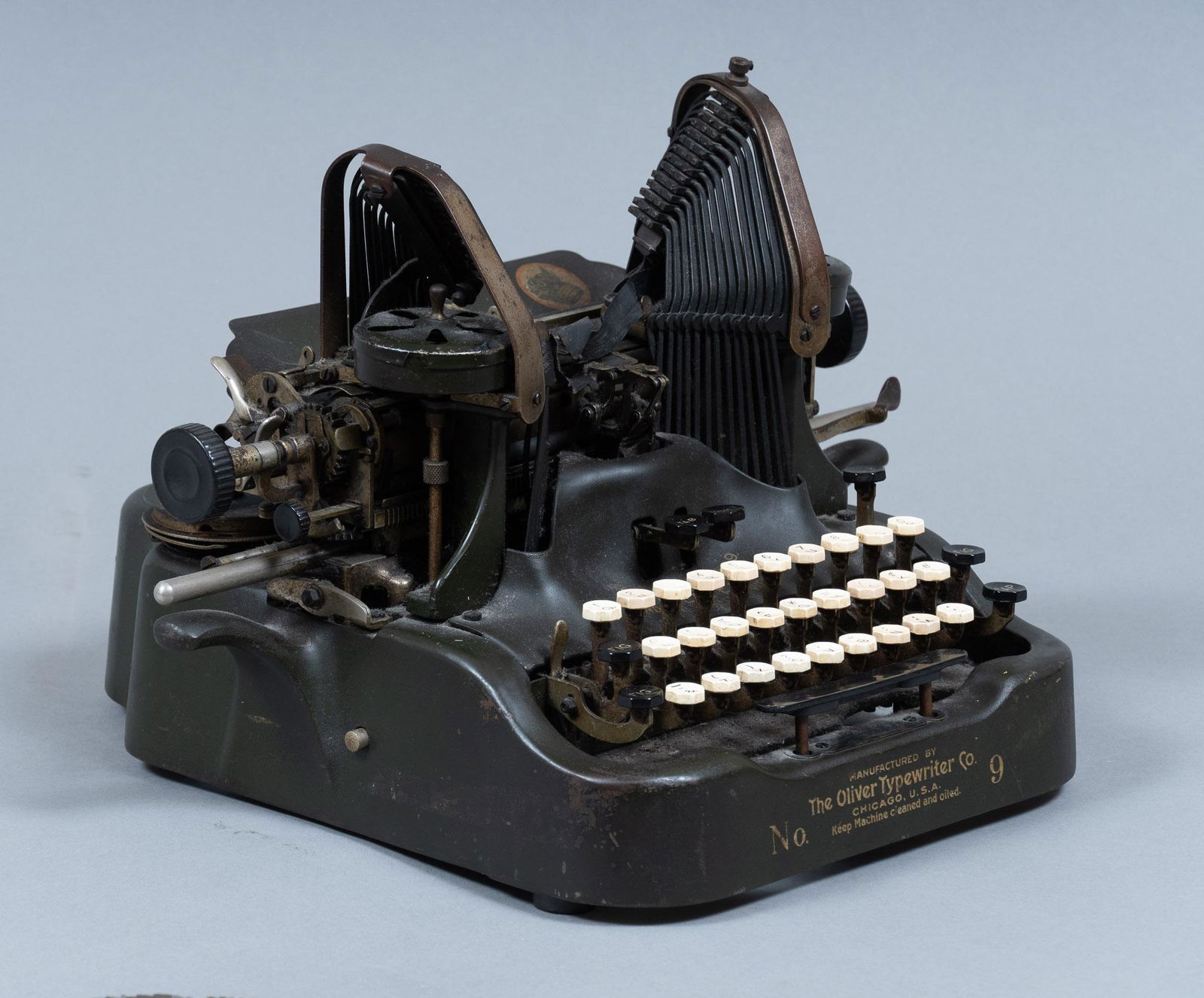 Early 20th C. Oliver Typewriter: Oliver No.9 typewriter, featuring dark green color, patented 1894-1913, marked by manufacturer 11"h x 16"w x 14"d Provenance: A prominent Terrell Hills, Texas collection We happily provide seamless