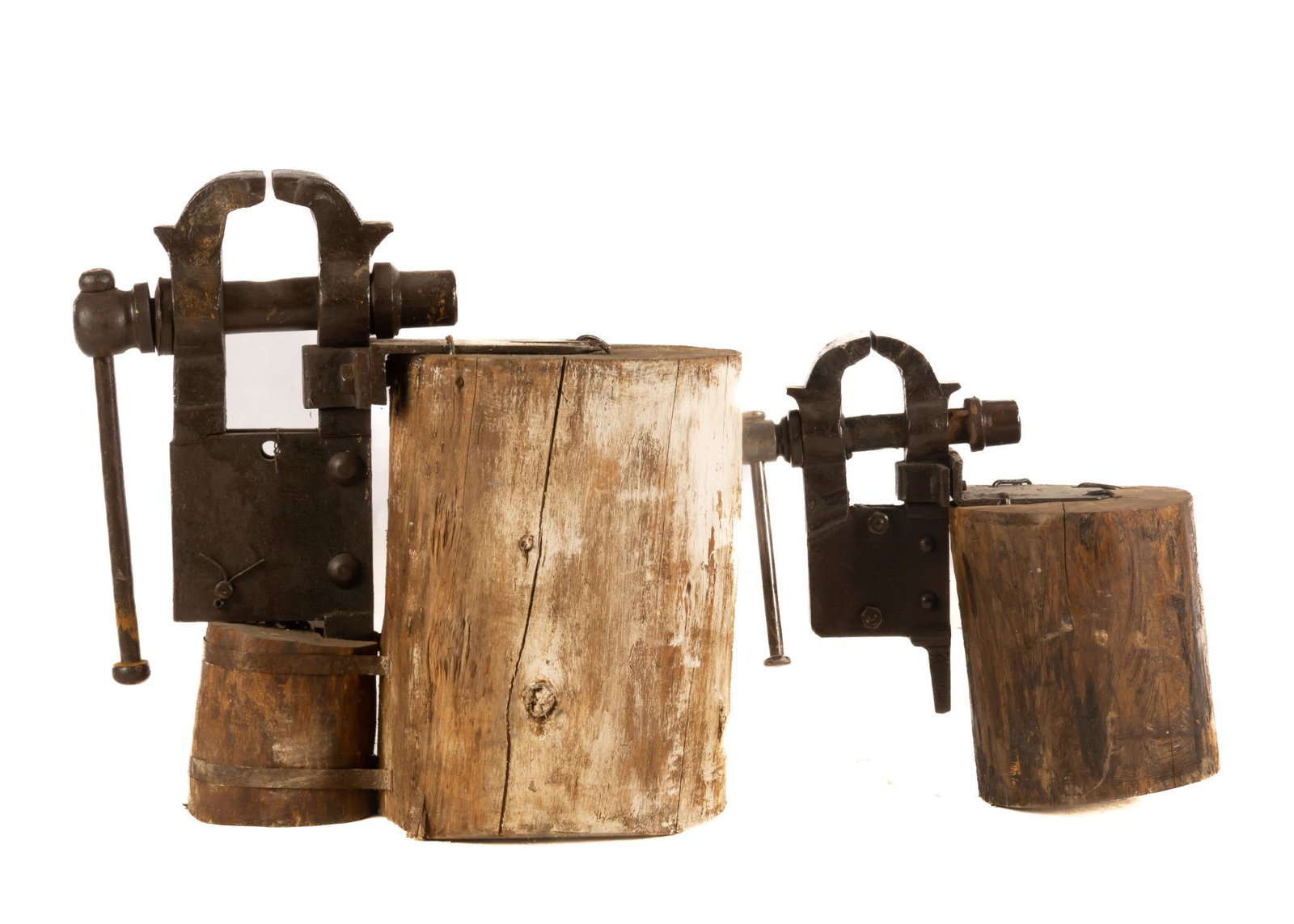 Pair of Primitive Vices on Log Bases: Pair of primitive metal vices, supported on wooden log bases 37"h x 28"w x 14.5"d / largest We happily provide seamless shipping services on everything we sell. Please email us at shipping@vogtauction