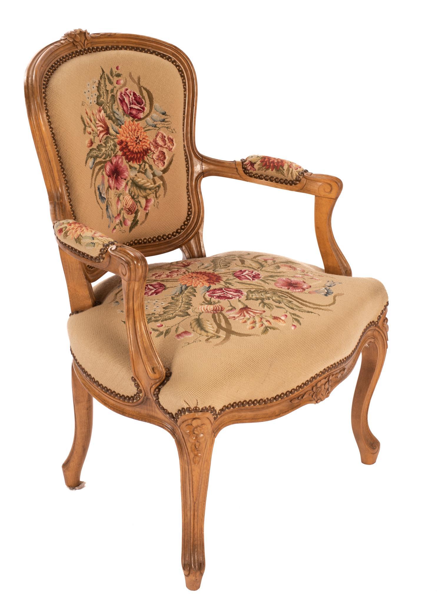 Louis XV Style Fauteuil Chair: Louis XV style fauteuil chair, having fruitwood frame, with carved floral accents, featuring needlepoint upholstery, metal stud trim, rising on cabriole legs 34"h x 23"w x 23"d We happily provide seam